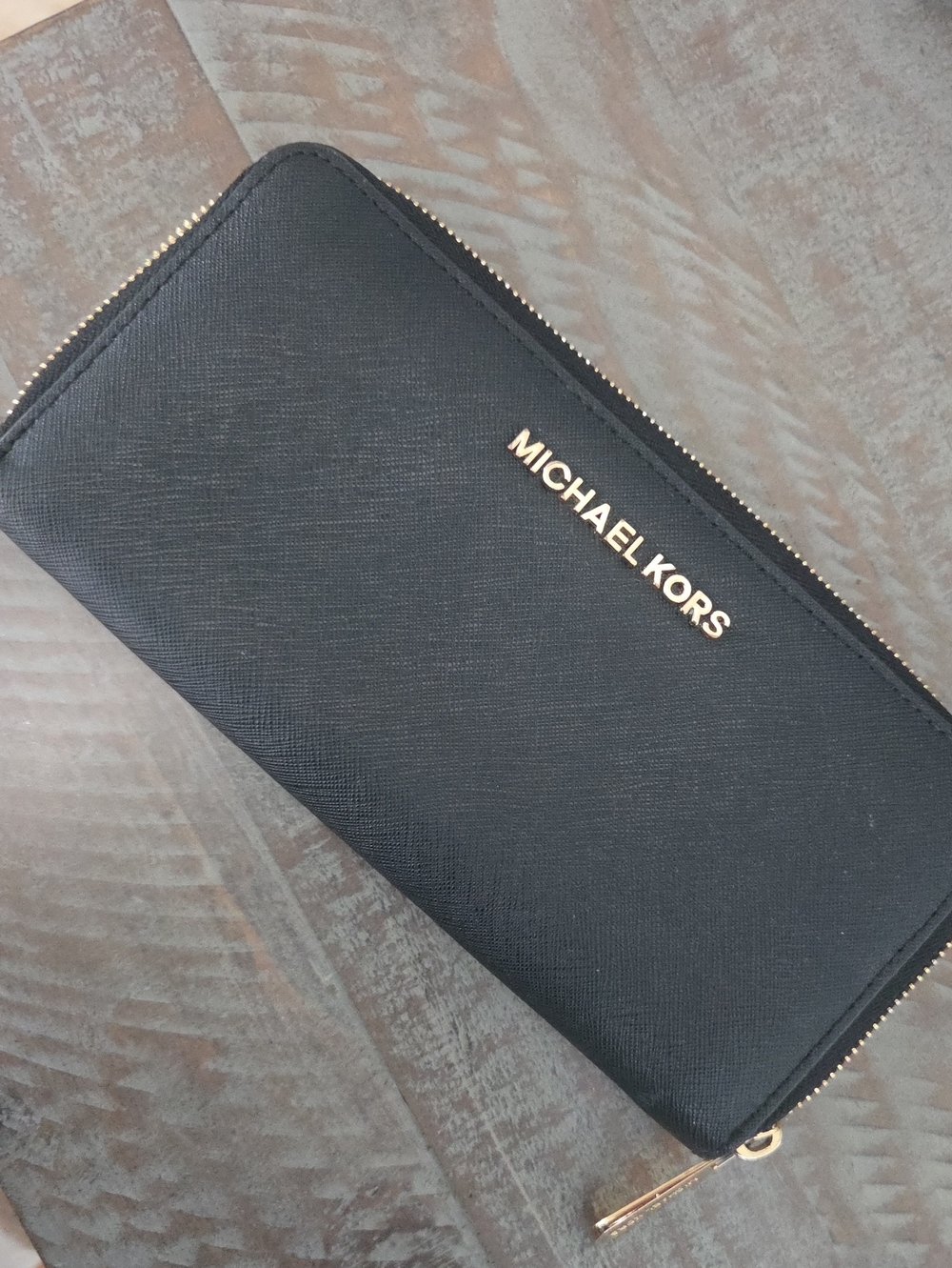 Michael Kors Black Leather Zip Wallet with Gold Logo Good condition.